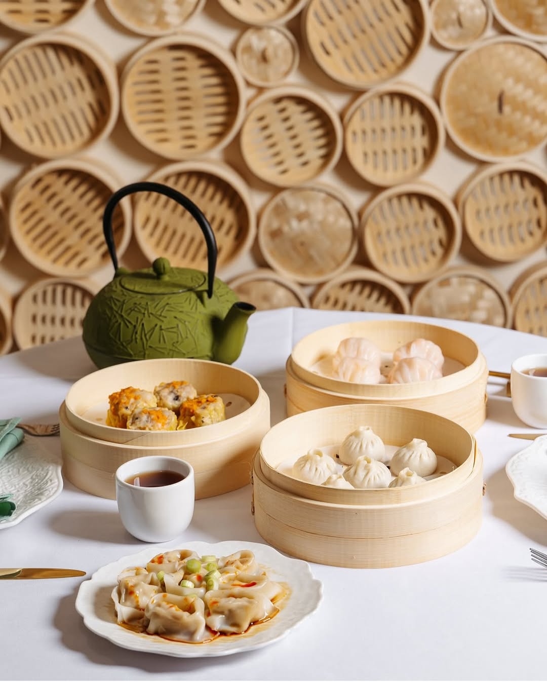 Dim sum spread with steamers and tea