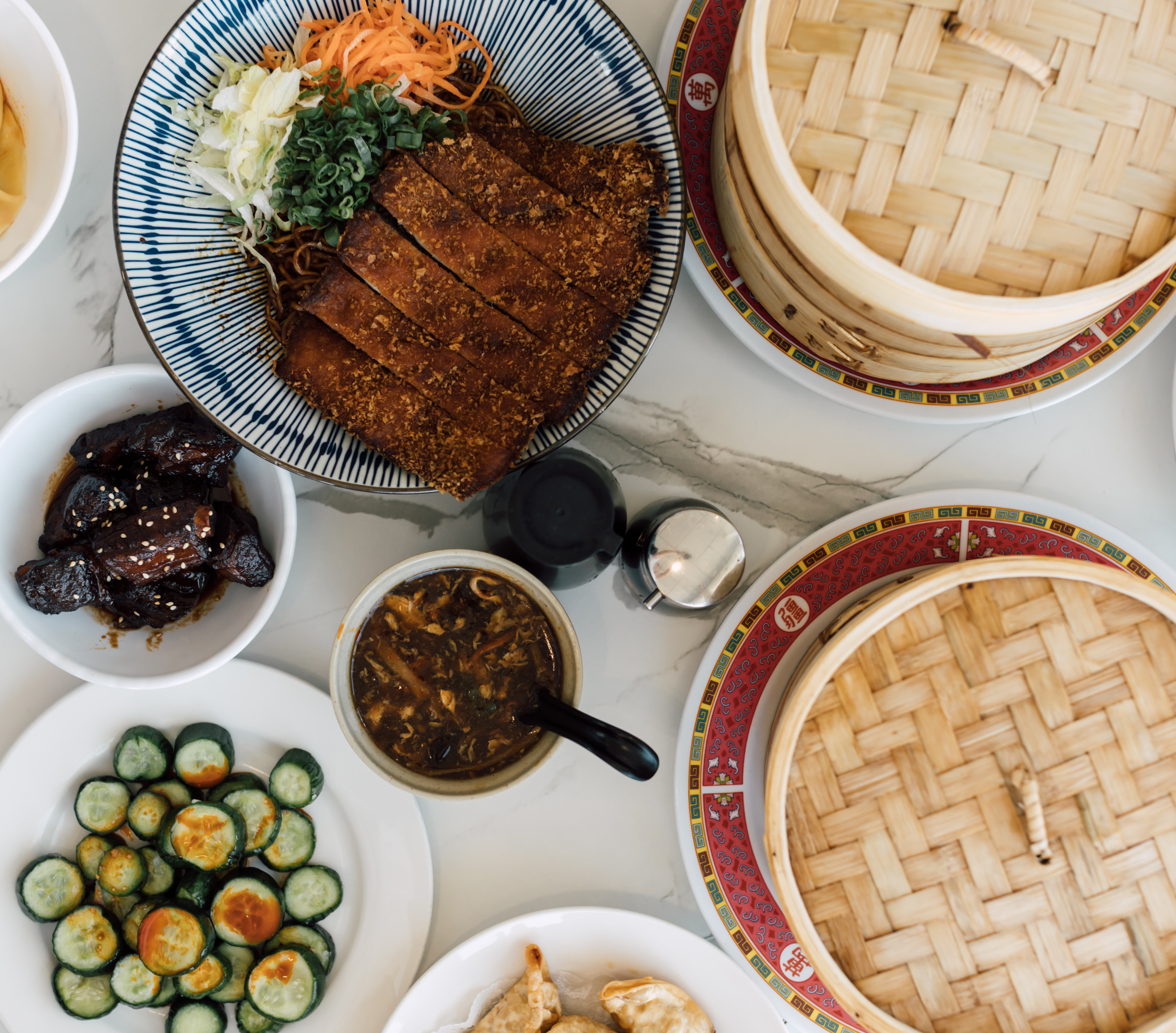 Overhead spread of dim sum with bamboo steamers
