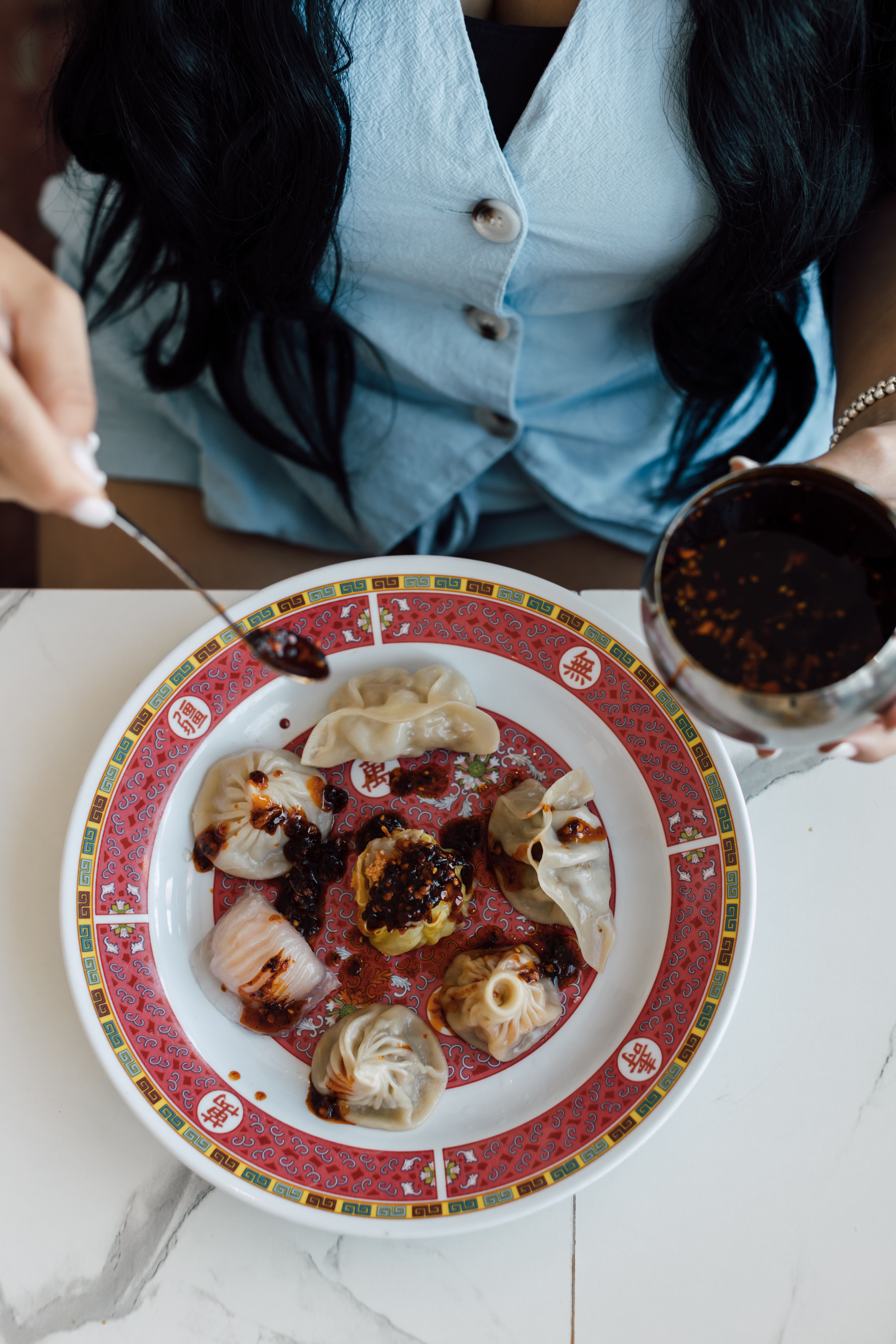 Assorted dumplings with chili oil on a plate